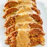 sliced of stuffed meatloaf with gravy on a platter