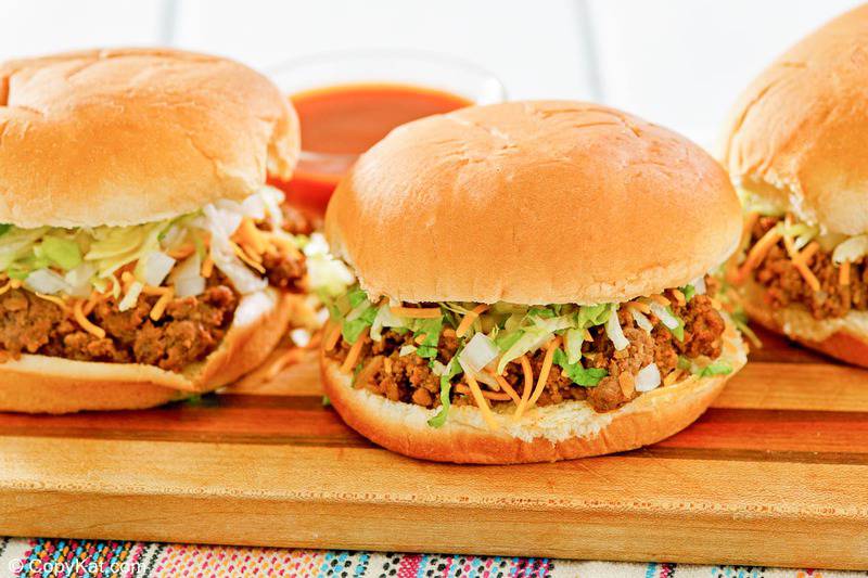 homemade Taco Bell Bell Beefer sandwiches and a small bowl of taco sauce