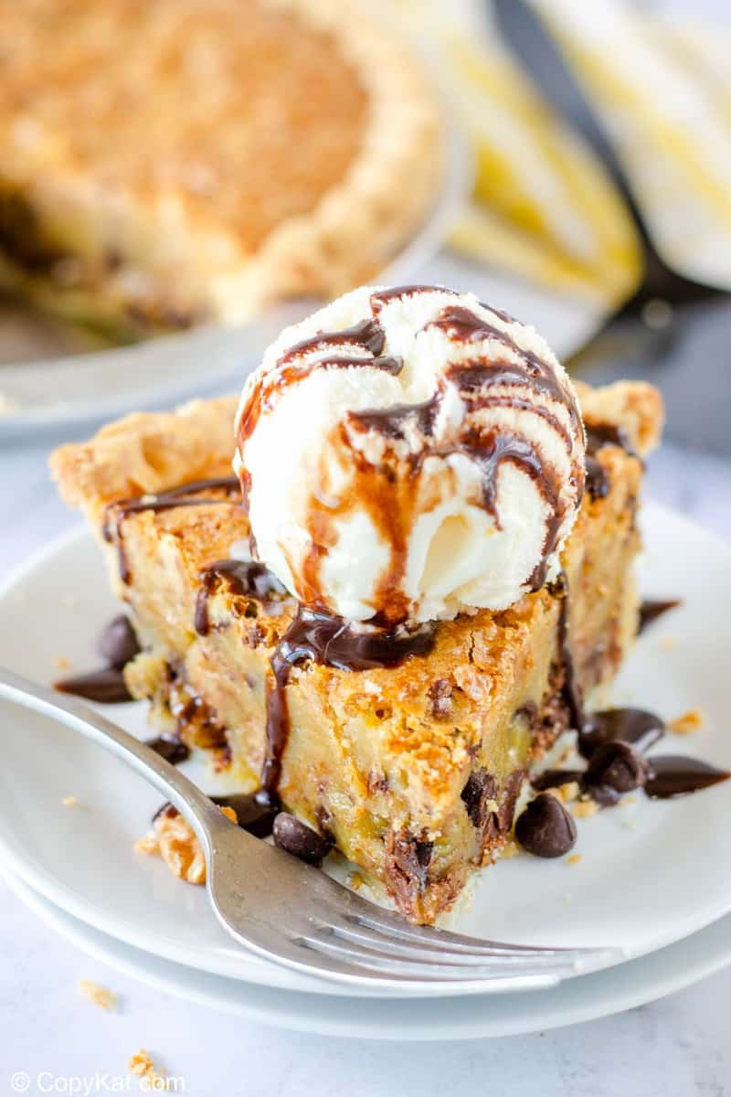 a slice of Toll House pie topped with ice cream and chocolate syrup