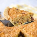 a slice of Toll House Pie on a spatula over the pie