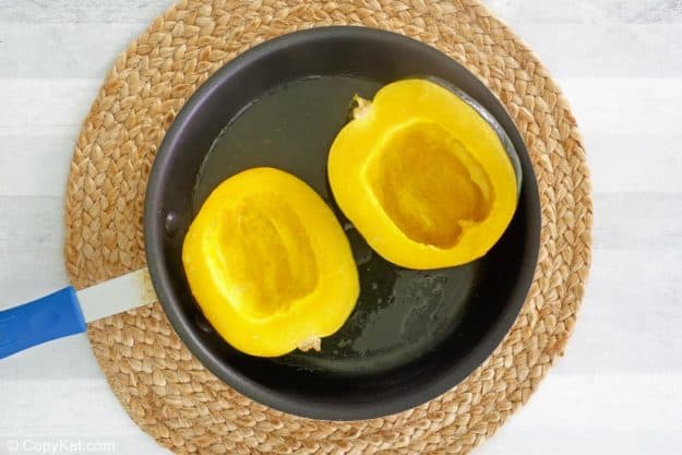 acorn squash cut in half and seeded.