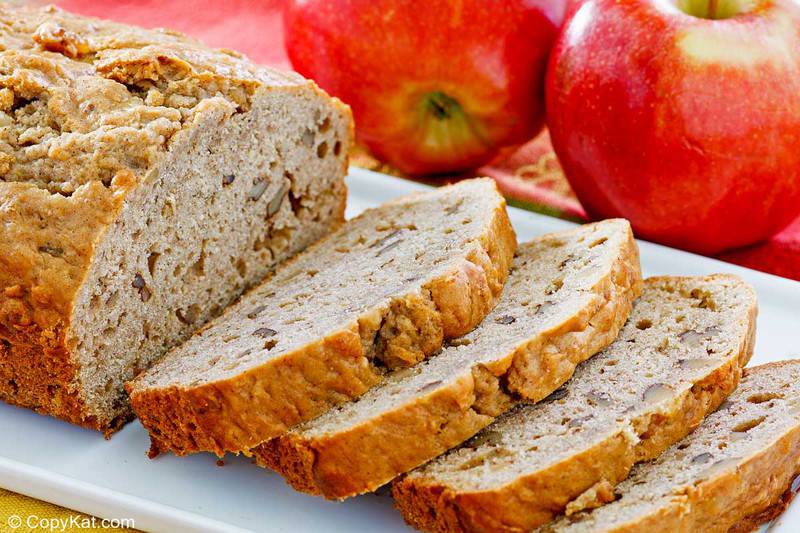 apple bread on a platter and two apples.