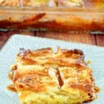 apple bread pudding with caramel sauce on a plate.