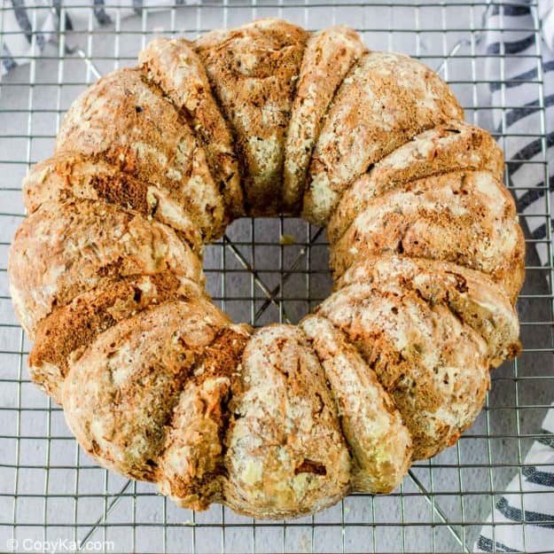 freshly baked apple spice cake cooling on a wire rack.