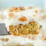 banana cake slice on a cake server over the cake.