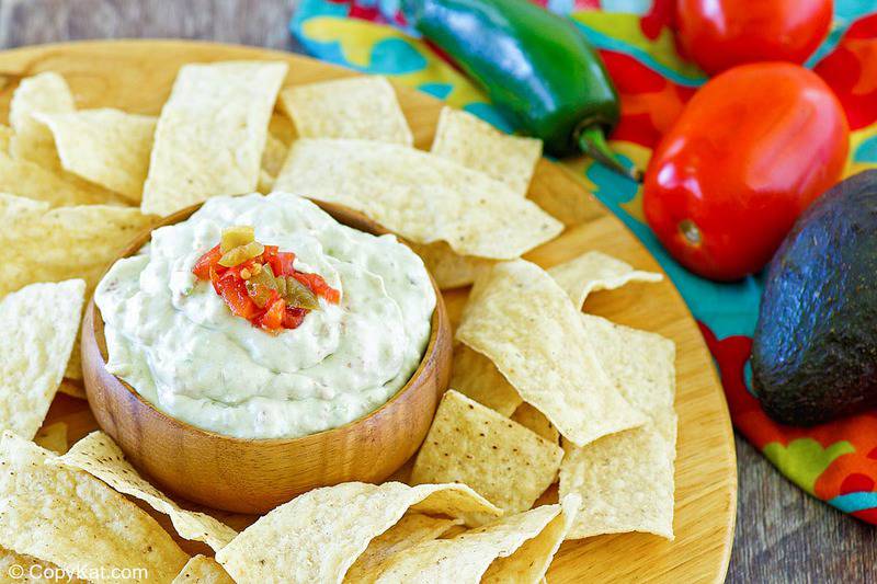 homemade Casa Ole creamy Mexican green sauce and tortilla chips on a platter.