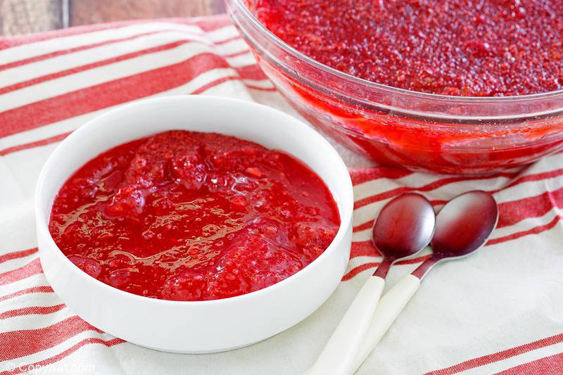 cranberry Jello salad in two bowls and two spoons.