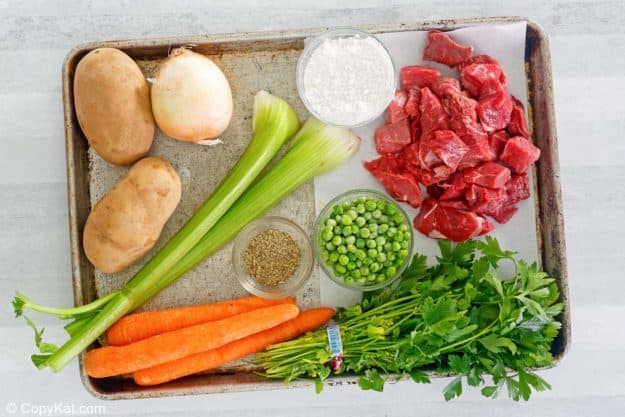 Dutch Oven beef stew ingredients on a baking sheet.