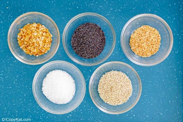 everything bagel seasoning ingredients in small bowls.
