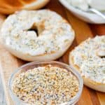 homemade bagel seasoning in a bowl, bagels, and cream cheese.