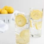 two glasses of homemade lemonade and lemons.