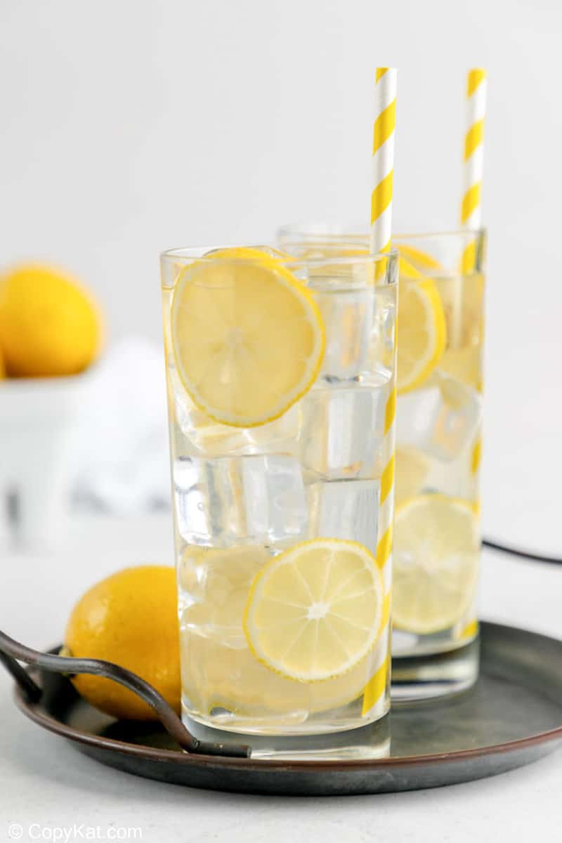 two glasses of homemade lemonade on a tray.