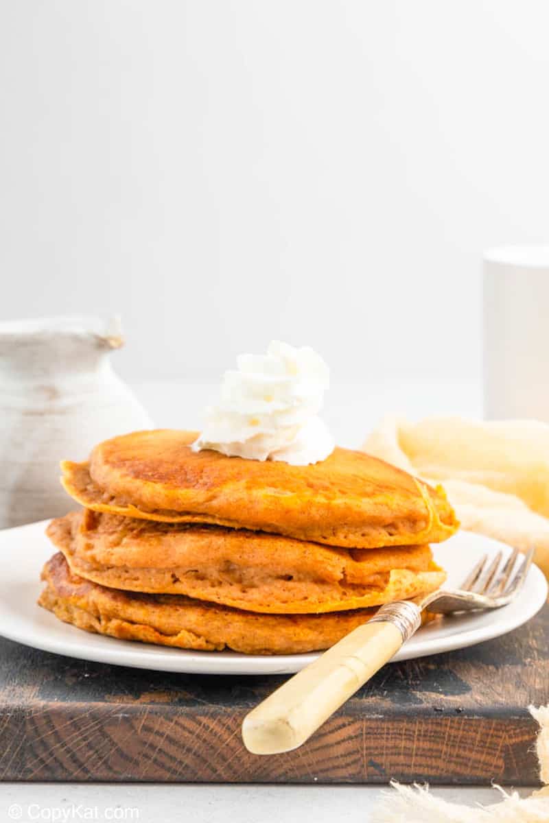 three homemade IHOP pumpkin pancakes on a plate.