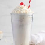 homemade Jack in the Box Rice Krispie Shake topped with whipped cream, a cherry, and cereal.