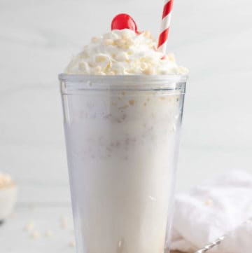 homemade Jack in the Box Rice Krispie Shake topped with whipped cream, a cherry, and cereal.