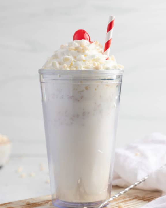homemade Jack in the Box Rice Krispie Shake topped with whipped cream, a cherry, and cereal.