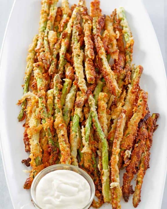 homemade Longhorn Steakhouse parmesan crusted asparagus on a platter.