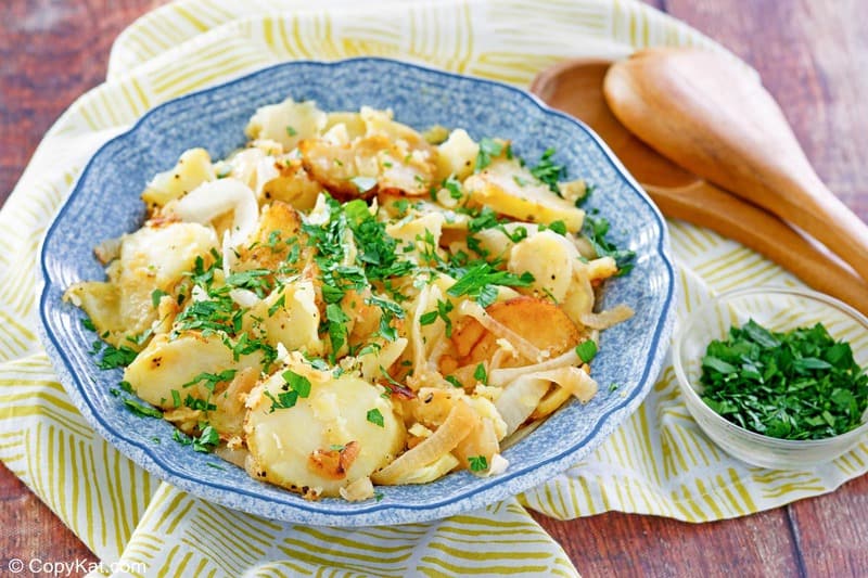lyonnaise potatoes in a blue serving bowl.