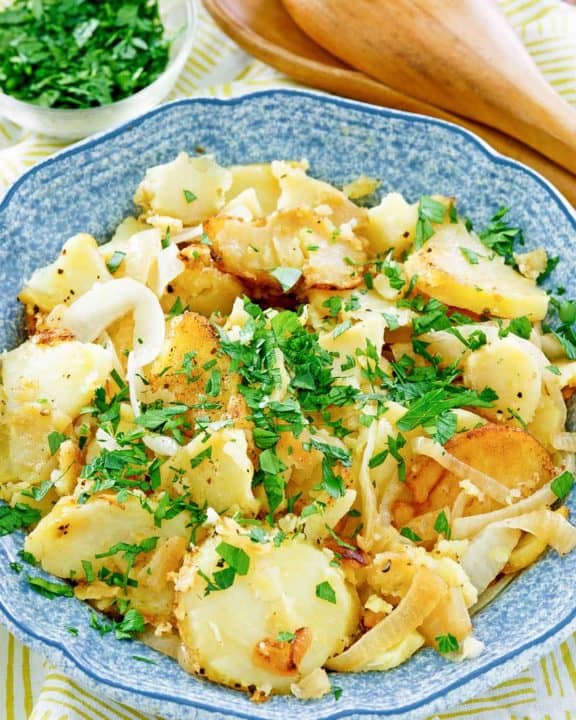 lyonnaise potatoes in a blue serving bowl.