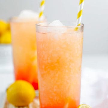 homemade McDonald's frozen strawberry lemonade in glasses with straws.