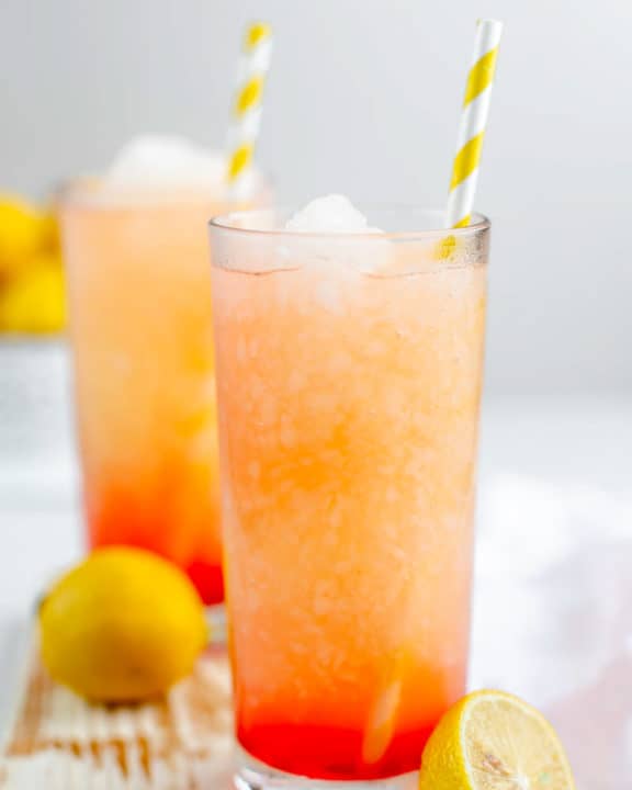 homemade McDonald's frozen strawberry lemonade in glasses with straws.