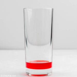 strawberry topping syrup in a glass.