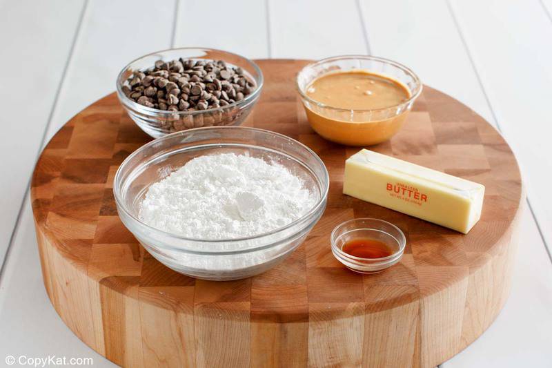 Reese's peanut butter eggs ingredients on a round wood cutting board.