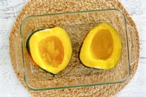 an acorn squash cut in half and seeded.