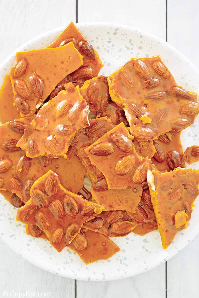 overhead view of homemade almond brittle on a plate.