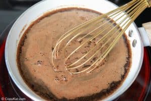 cinnamon brown sugar syrup cooking in a pan.