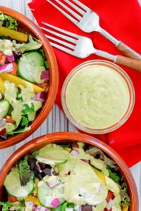 homemade Chick Fil A avocado lime ranch dressing in a bowl and on salads.