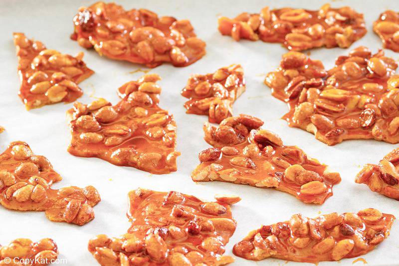 peanut brittle candy pieces on parchment paper.
