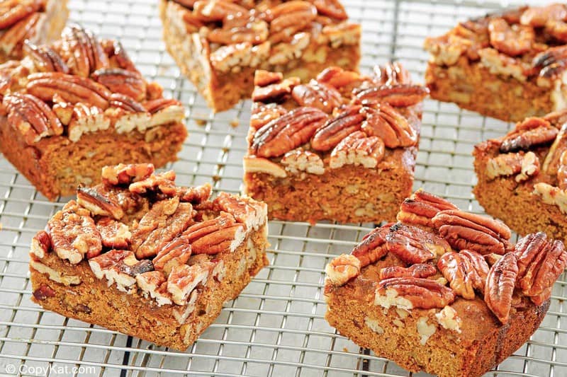 several pecan pie brownies on a wire rack.