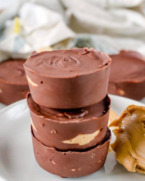 a stack of homemade Reese's peanut butter cups on a plate.