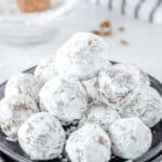 a stack of rum balls on a plate.