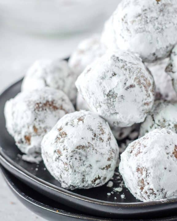 a pile of rum balls on a plate.