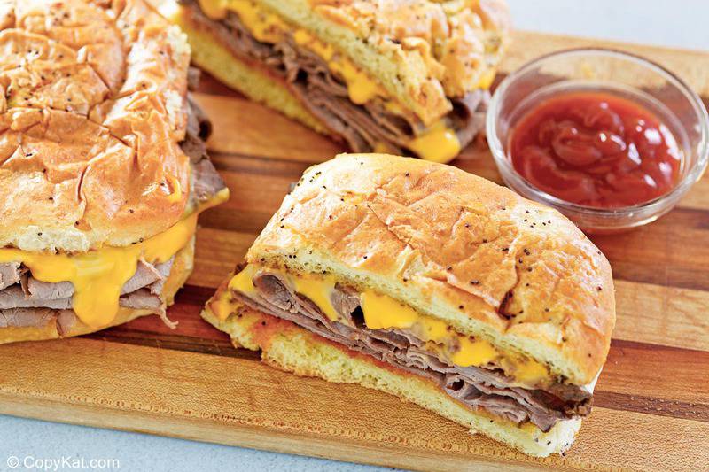homemade Arby's beef and cheddar sandwiches and a bowl of red ranch sauce.