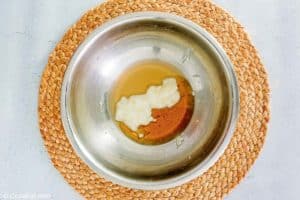 honey roasted carrots coating ingredients in a bowl.