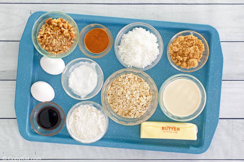 oatmeal cake with coconut pecan frosting ingredients on a tray.