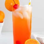 homemade Olive Garden Venetian Sunset drink garnished with a cherry and orange slice.
