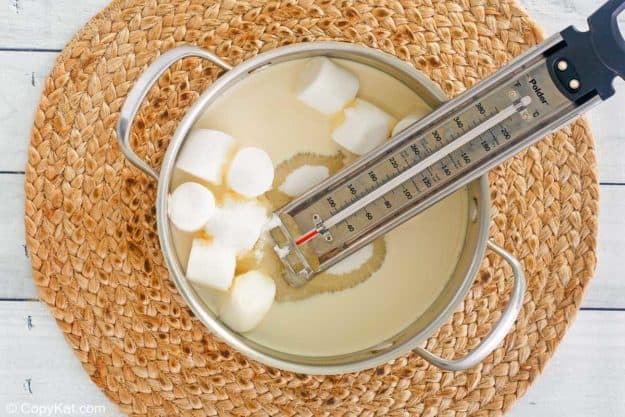 evaporated milk, sugar, marshmallows, and candy thermometer in a pan.