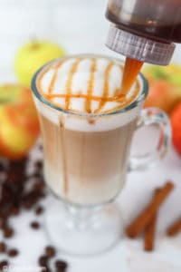 drizzling apple cinnamon syrup on a macchiato.