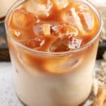 homemade Starbucks iced apple crisp macchiato and two cinnamon sticks.