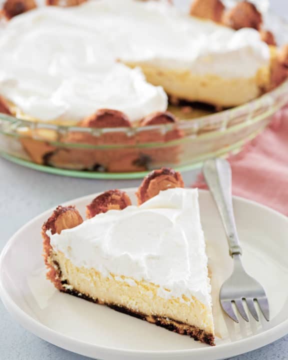 tiramisu cheesecake in a pie plate and a slice on a plate.