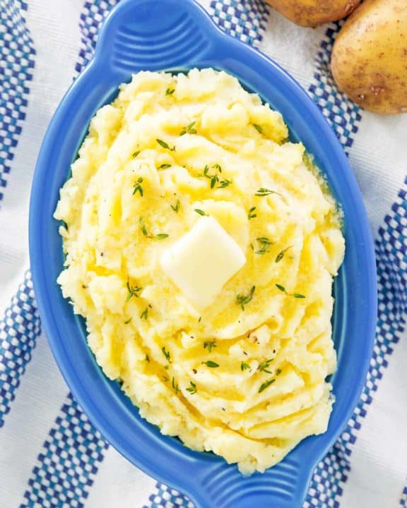 overhead view of yukon gold mashed potatoes in a serving dish.