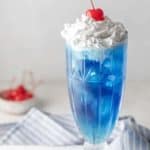 homemade Ruby Tuesday Blue Smurf Punch Drink and a bowl of cherries.