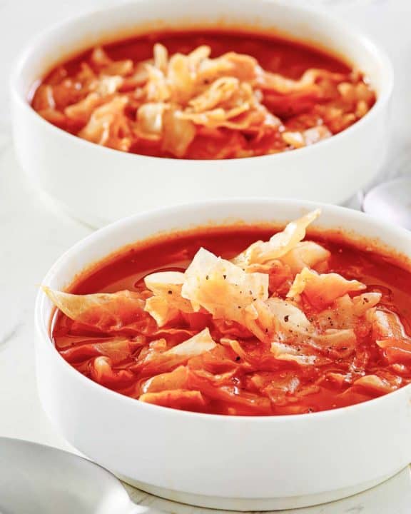 two bowls of homemade cabbage soup.