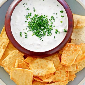 overhead view of clam dip and crackers on a platter.
