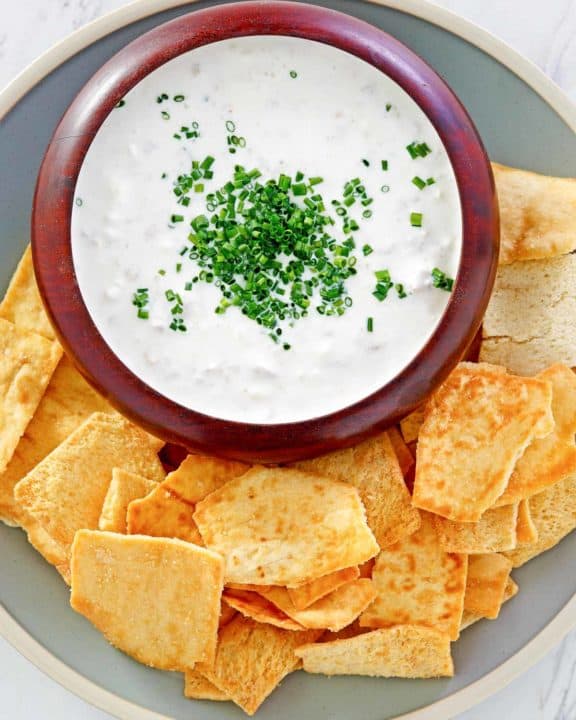overhead view of clam dip and crackers on a platter.