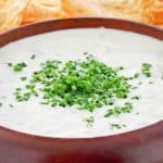 closeup of clam dip in a wood bowl.